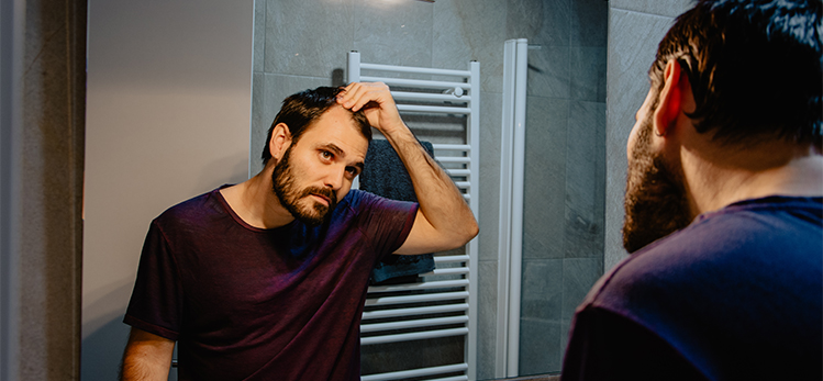 worried-young-white-man-looks-himself